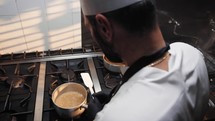 Chef handling a pot controlling the quality of his work 