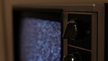Changing channels on a vintage television set with no remote
