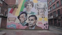 The mural on the gable end of The Molly House on Richmond Street honours Manchester's most famous gay people. Computing pioneer Alan Turing (bottom right), suffragette Emmeline Pankhurst (top left), writer Quentin Crisp (bottom left) and drag queens Foo Foo Lammar (top right) and Anna Phylactic (top) are all pictured.