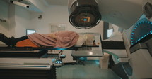 Patient getting Radiation Therapy Treatment inside a modern radiotherapy room
