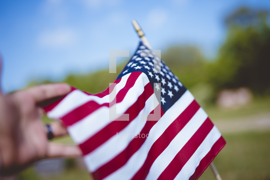 hand reaching towards an American flag 