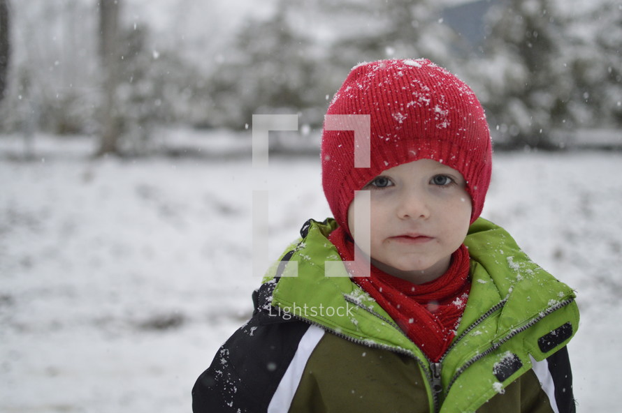boy child standing in winter snow 