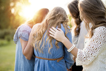 women in a prayer circle 