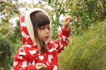 a toddler girl in a hooded jacket 