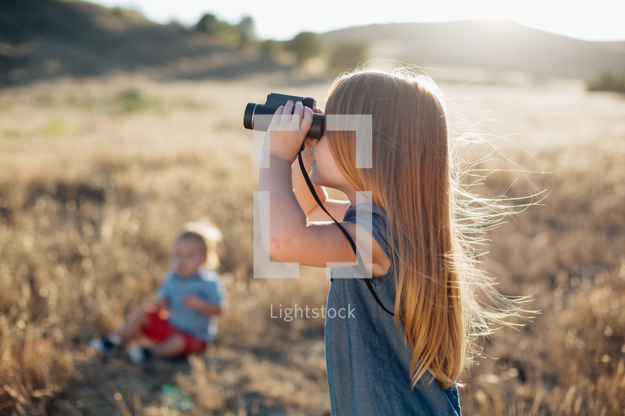 a child with binoculars 