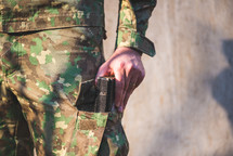 man in military uniform holding a Bible 