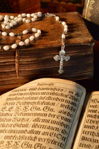 a rosary on an old Bible 