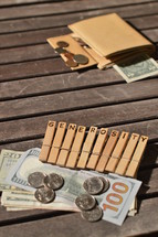 Plenty of money donated attached to wooden clothespins with the word GENEROSITY burnt into.