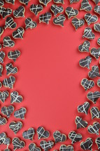 frame out of home made heart shaped cookies with chocolate on red background