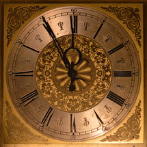 five minutes before twelve o'clock at a ancient golden clock. 
