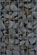 rocks behind metal fencing 