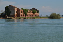 ruins of a brick building along a shore 