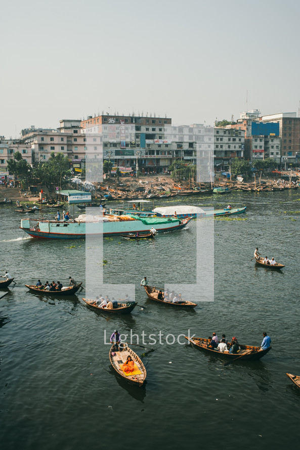 Boats with fishermen in Dhaka river in Bangladesh