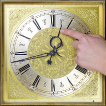 person pointing to the hands of a clock 