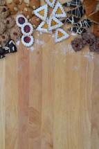 Christmas cookies border or frame. 
border, frame, negative space, Christmas, gingerbread, cookies, cookie, biscuit, delicious, tasty, yummy, delicate, colorful, colourful, multicolored, bake, baking, eating, food, bakery, bakeshop, variety, diversity, richness, nibble, snack, sweets, sweet, pastry, goods, pastries, groceries, edible, eatable, consume, cinnamon, nut, macaroons, marzipan, jam, marmalade, jelly, cooky, chocolate, nougat, choice, selection, assortment, goodies, abundance, plenty, opulence, tradition, self made, handmade, baked, fresh, sugar, icing sugar, powdered sugar, dough, breadboard, bread-board, bread board, biscuits, almond, season, Christmas time, Christmastide, cut out, butter, cut, vanilla crescents, heart, hearts, fir tree, fir trees, walnut, hazelnut, coconut, surrounding, edge, ribbon