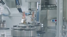 Advanced robots placing parts in an automated assembly line