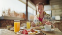 Young woman eats breakfast