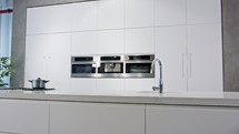 Tracking shot of a large luxury kitchen with white modern design