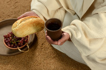 Jesus' hands holding bread and wine.