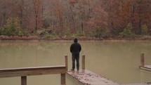 Inspiration, Lonely, Alone, Zen, Peaceful, Cold - Unrecognizable Man with Black Jacket Standing on the Lake Side Autumn Fall Foliage Trees Arkansas