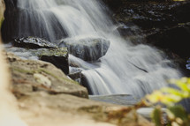 Waterfall in rock-lined stream.
