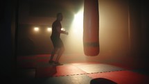 athlete practices boxing to bags in gym