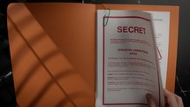 Analyzing Top Secret Documents on table