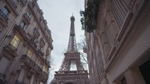 The majestic Eiffel Tower as seen from the residential area of Rue de l'Université, Paris.