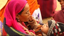 A mother holding her child in India 