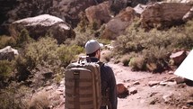 a man hiking alone through the desert mountains 