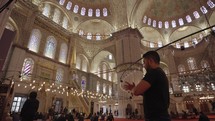 Muslim Man Salah salat Pray inside The Blue Mosque Sultan Ahmed Sultanahmet Camii Ottoman era historical imperial mosque Istanbul, Turkey
