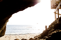 view of the ocean and beach from a cave