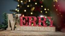 Merry Christmas Sign under Christmas Tree