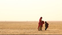 mother and son walking through a desert 