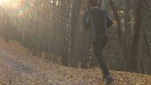man running along a path in fall 