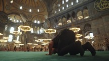 Islam Muslim Man Salah Salat Pray inside Hagia Sophia Ayasofya Camii Mosque Istanbul, Turkey