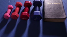 Bible and weights on a mat 