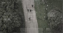Surveillance drone camera view of terrorist squad walking with weapons