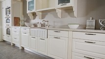 Tracking shot of a large luxury kitchen with white classic design