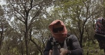 POV footage of armed terrorists patrolling a forest area