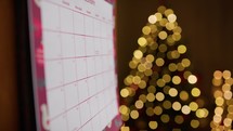 December calendar with blurred Christmas tree background 
