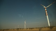 Modern windmills turning in the wind.