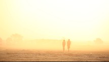 men walking in a desert and bright sunlight 