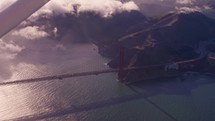 flying over golden gate bridge San Francisco by plane at golden hour
