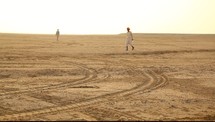 man walking in a desert 