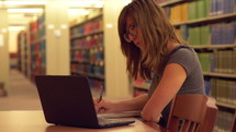 A female college student studying in the library