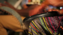 Men playing traditionals bongos (with change of focus)