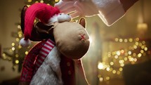 Santa Claus caresses Christmas reindeer Toy