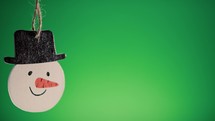 Christmas snowman decoration with green background 