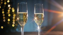 beam of light crashing into two champagne glasses
